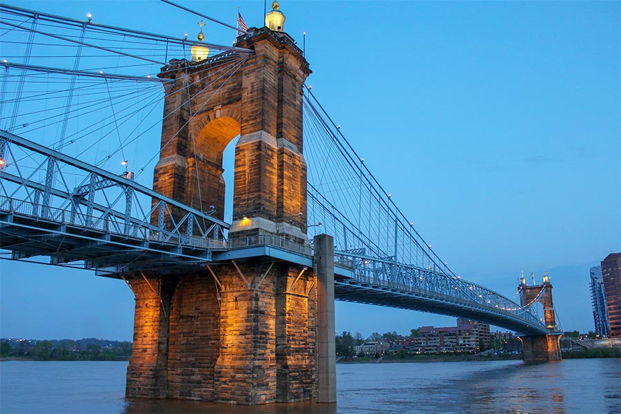 Crestview Hills, KY Insurance - View of the John a. Roebling Suspension Bridge Connecting Ohio and Kentucky Across the Ohio River, Lit up at Dusk